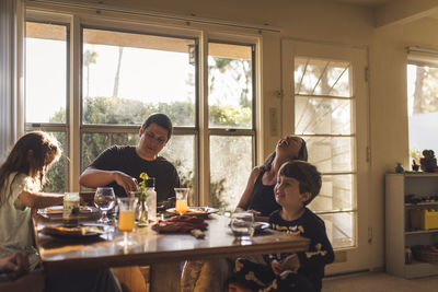 Happy family having breakfast at dining table