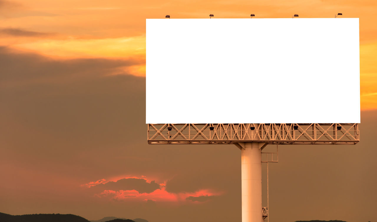 INFORMATION SIGN AGAINST ORANGE SKY