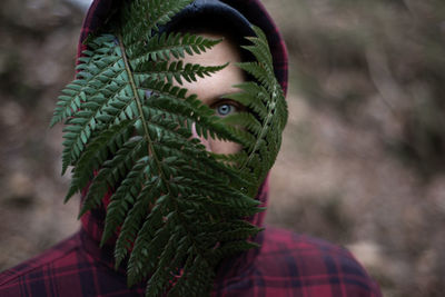 Close-up portrait of man holding leaves