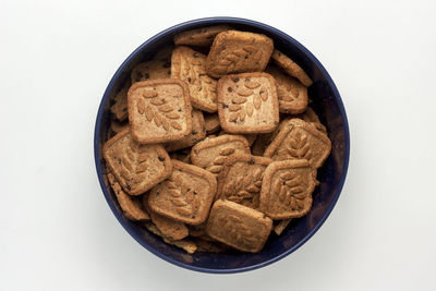 High angle view of cookies in bowl against white background