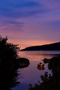 Scenic view of lake against romantic sky at sunset