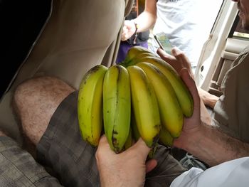 Midsection of man holding fruits