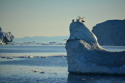 View of statue by sea against sky