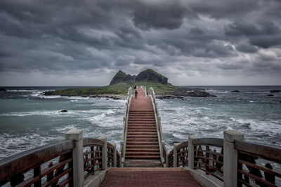 Scenic view of sea against storm clouds