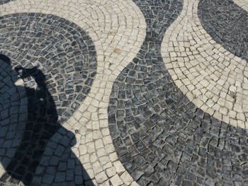 Low section of shadow on footpath