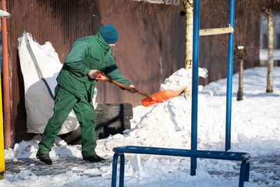 Low section of man working on snow