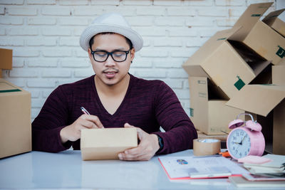 Portrait of man using smart phone on table