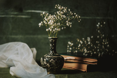 Close-up of white flower vase on table