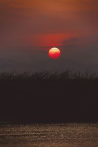 Scenic view of sea against romantic sky at sunset