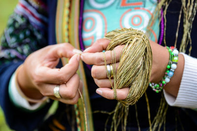 Midsection of woman weaving