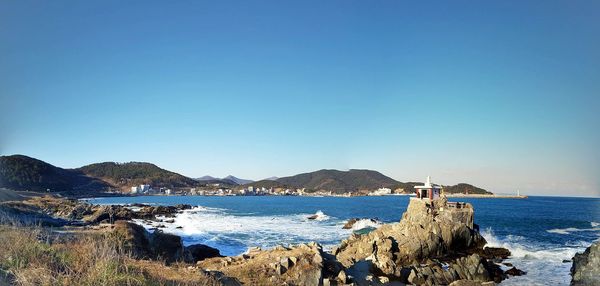 Panoramic view of sea against clear blue sky