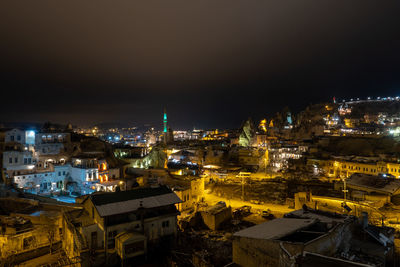 High angle view of illuminated buildings in city at night