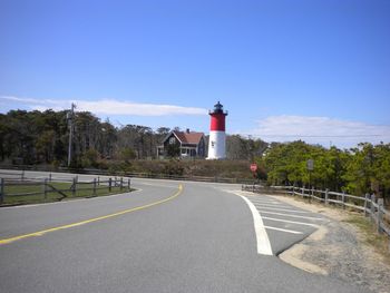 Road by lighthouse against sky