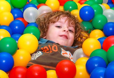 Portrait of boy with ball in balloons