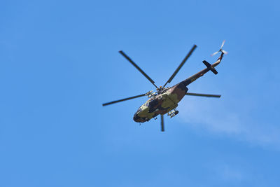 Low angle view of airplane against clear blue sky