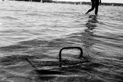 Midsection of woman wading in lake