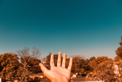 Midsection of person against clear sky