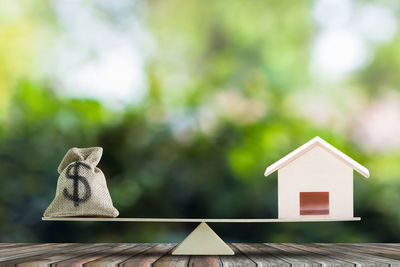 Close-up of birdhouse on table against house