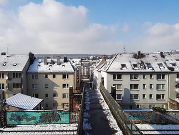 Buildings against cloudy sky