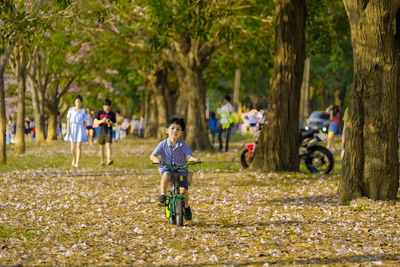 Full length of boy riding bicycle at park