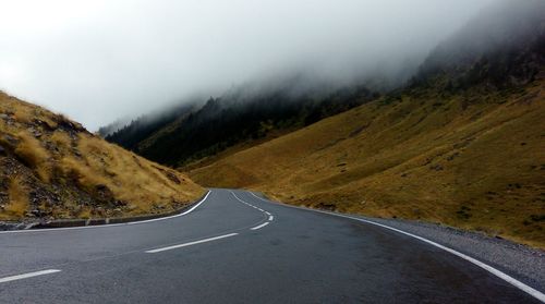 Road amidst mountains against sky