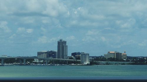 Cityscape against cloudy sky