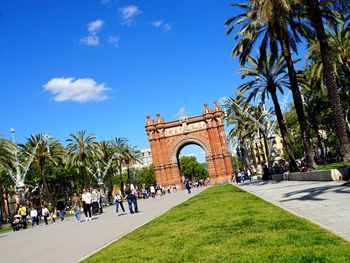 Tourists against blue sky