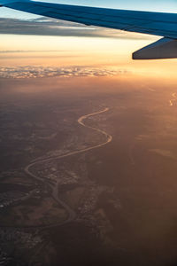 Aerial view of clouds seen through airplane window