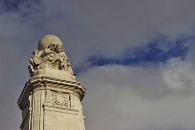 Low angle view of statue against sky