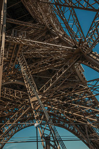 View of iron structure of the eiffel tower in a sunny day in paris. the famous capital of france.
