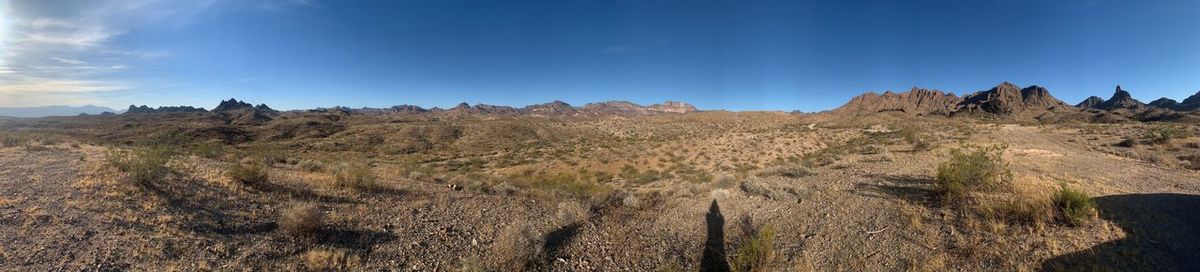 Panoramic view of landscape against blue sky