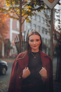 Portrait of a smiling young woman in city