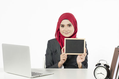 Portrait of smiling young woman using smart phone