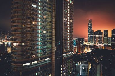 Illuminated modern buildings in city at night