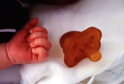 Close-up of baby hand on bed