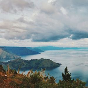 Scenic view of mountains against cloudy sky