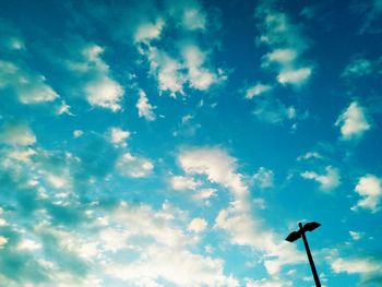 Low angle view of street light against cloudy sky