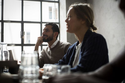 Businesswoman with male colleague in discussion during meeting at office