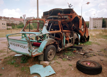 Abandoned car against sky