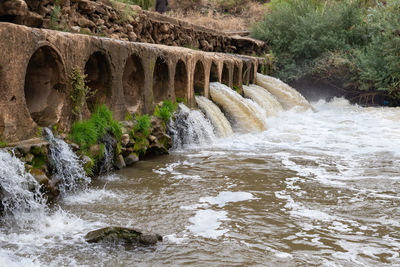 Arch bridge over river stream