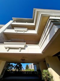 Low angle view of buildings against clear blue sky