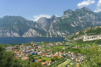 Aerial view of townscape and mountains against sky