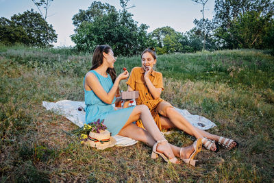 Summer party, outdoor gathering with friends. two young women, friends at the picnic having fun on