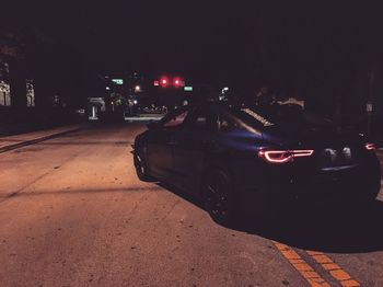 Cars on city street at night