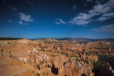 Scenic view of rock formations against blue sky