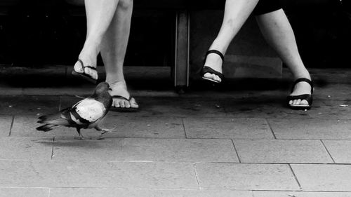 Low section of woman standing on tiled floor