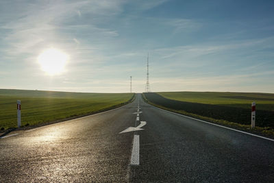 Road passing through landscape against sky