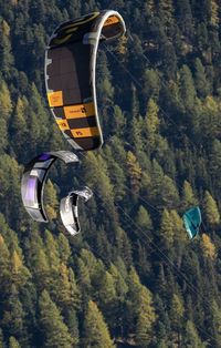 View of hot air balloon flying over mountain