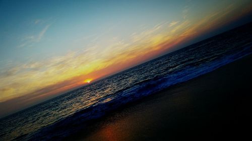 Scenic view of sea against cloudy sky