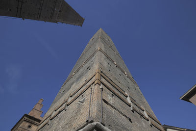 Low angle view of old building against blue sky